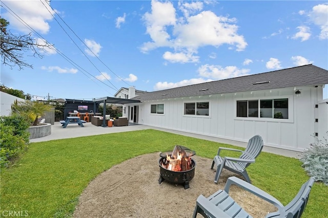 back of house featuring a lawn, a patio area, a pergola, and an outdoor living space with a fire pit