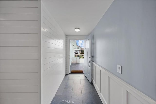 doorway to outside with dark tile patterned flooring