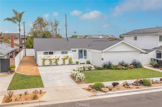 view of front facade featuring a front yard and a garage