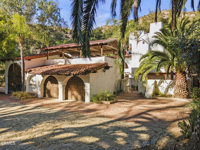 mediterranean / spanish home featuring a garage