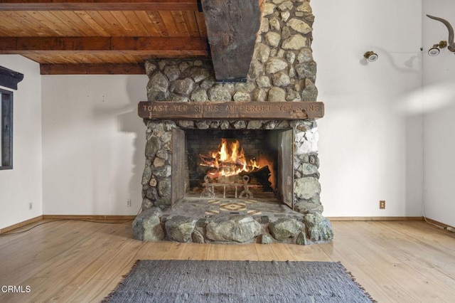 interior details featuring wooden ceiling, beam ceiling, a fireplace, and wood-type flooring