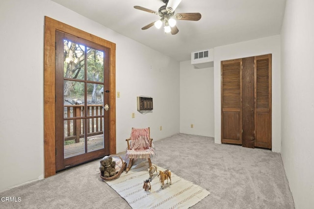 living area featuring ceiling fan and carpet floors