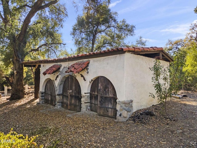 view of property exterior with an outdoor structure