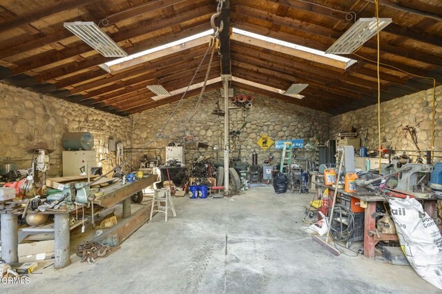 garage featuring a workshop area and wooden ceiling