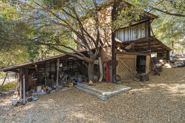 back of property featuring an outbuilding