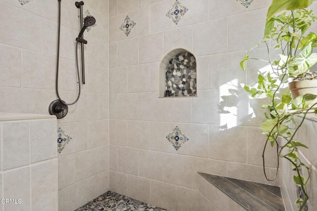 bathroom with a tile shower