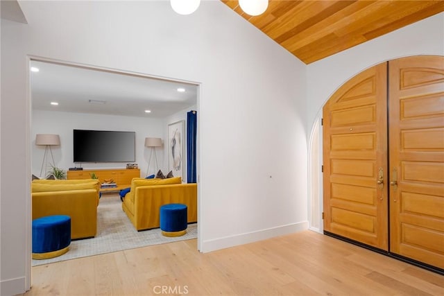 entrance foyer featuring wood-type flooring, vaulted ceiling, and wooden ceiling