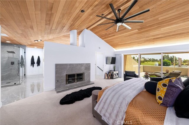 carpeted bedroom with wooden ceiling, vaulted ceiling, ceiling fan, access to exterior, and a fireplace