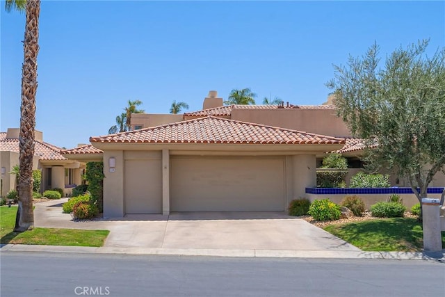 mediterranean / spanish-style house with a garage