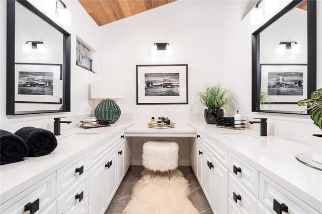 bathroom with vanity, wood ceiling, and vaulted ceiling