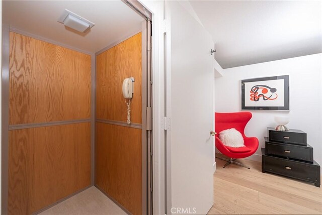 hall featuring light hardwood / wood-style floors and elevator