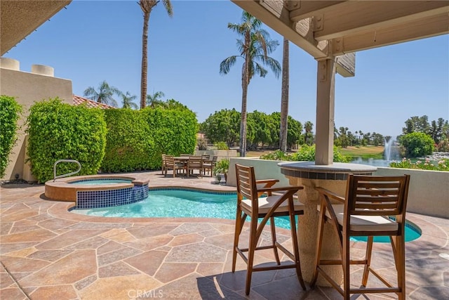 view of pool with an in ground hot tub and a patio