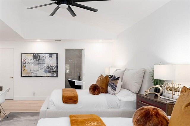 bedroom featuring light wood-type flooring, ceiling fan, and lofted ceiling