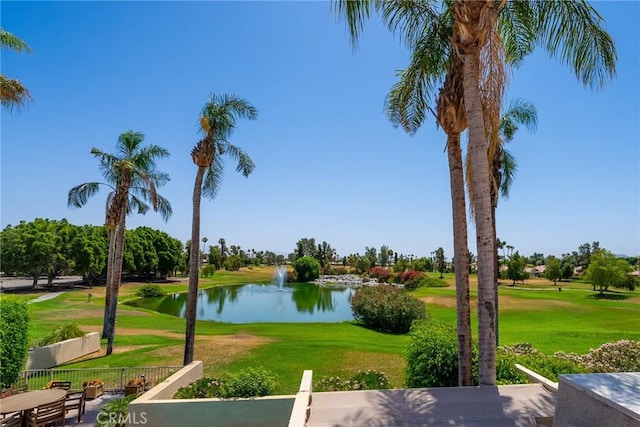 view of home's community with a yard and a water view