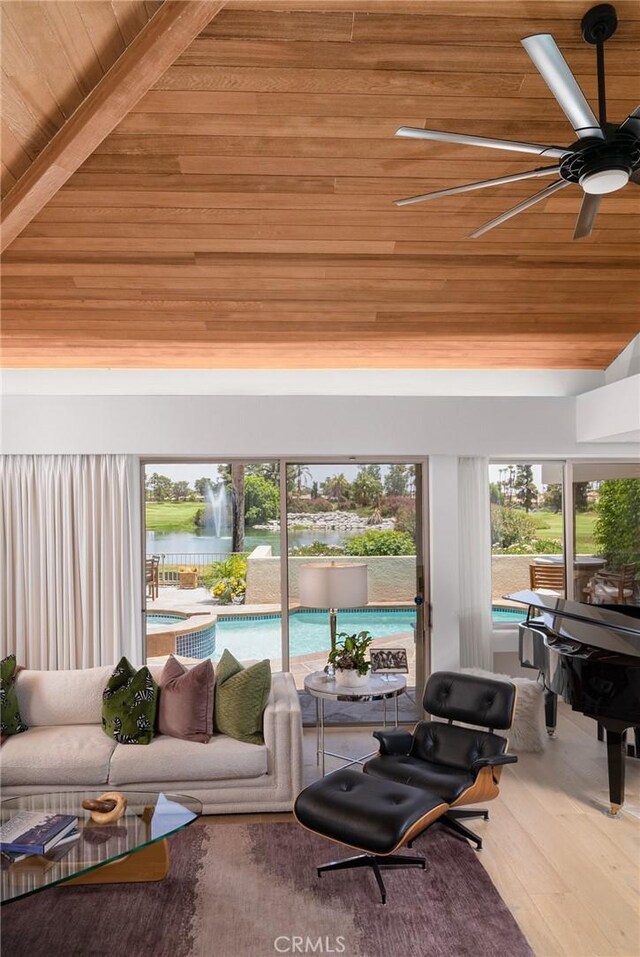 sunroom featuring ceiling fan, wood ceiling, and vaulted ceiling