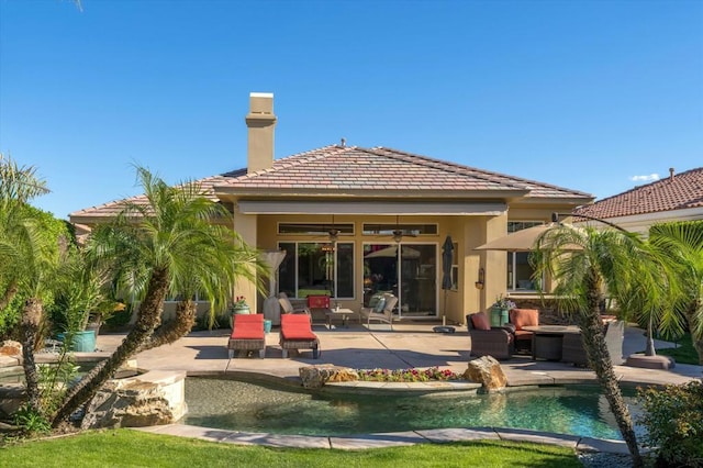 back of property featuring an outdoor living space, a patio, and ceiling fan