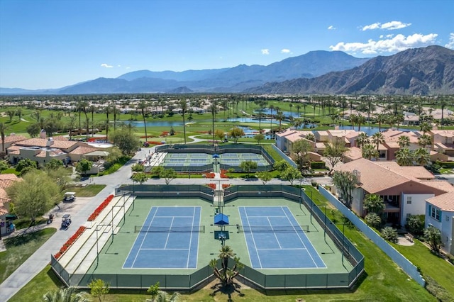 birds eye view of property with a water and mountain view