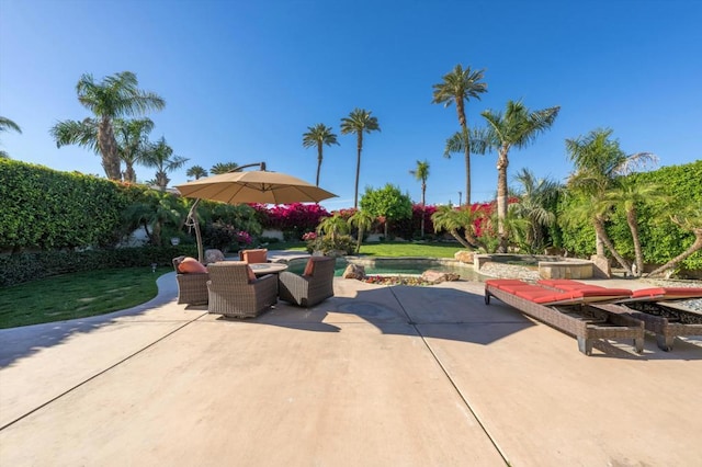 view of patio featuring an in ground hot tub