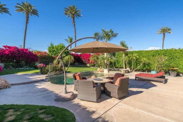 view of patio / terrace featuring a swimming pool with hot tub