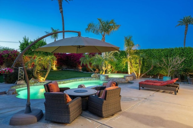 view of patio / terrace featuring a pool with hot tub