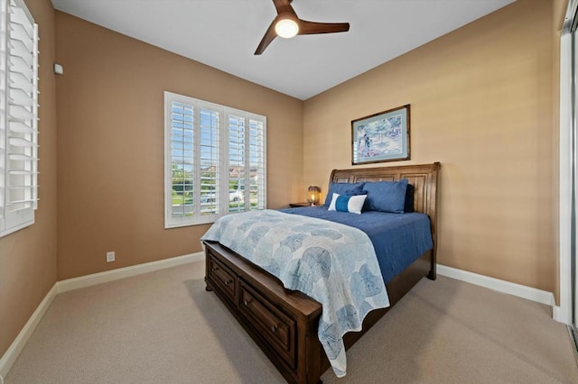 bedroom featuring light carpet and ceiling fan