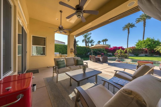 view of patio with ceiling fan, a swimming pool, and an outdoor hangout area