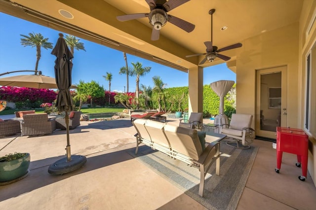 view of patio with an outdoor living space and ceiling fan