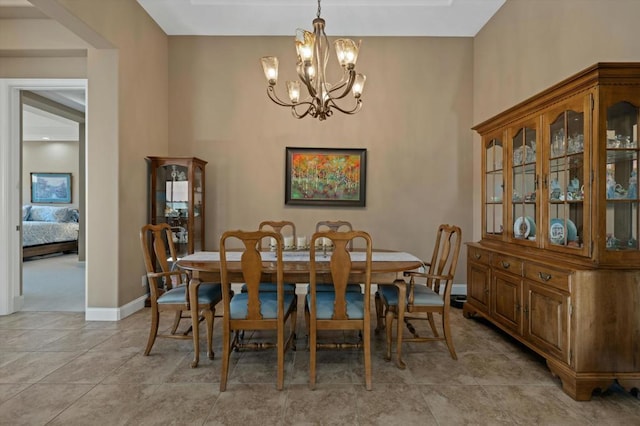 dining room featuring an inviting chandelier and light tile patterned flooring