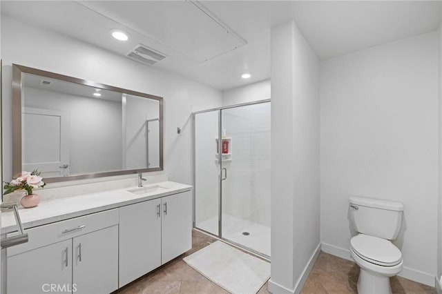 bathroom featuring tile patterned floors, toilet, vanity, and walk in shower