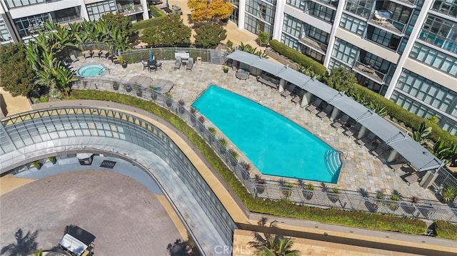 view of swimming pool with a community hot tub