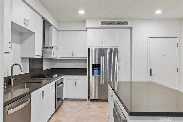 kitchen featuring stainless steel appliances, white cabinetry, and sink