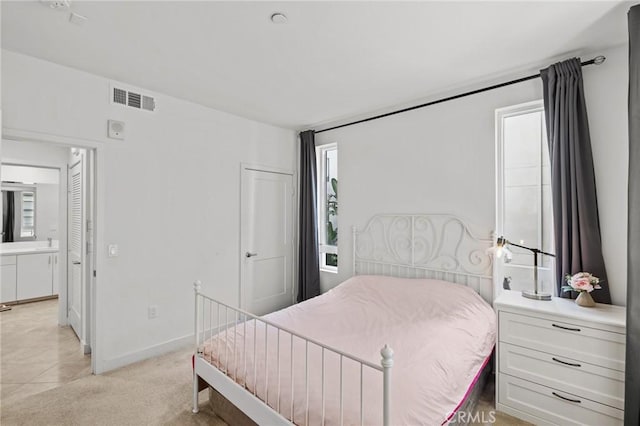 bedroom with multiple windows and light carpet