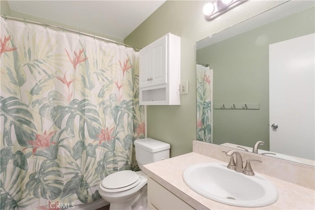 bathroom featuring toilet and vanity