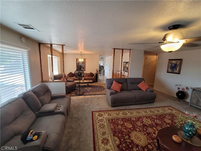 living room with ceiling fan and a textured ceiling