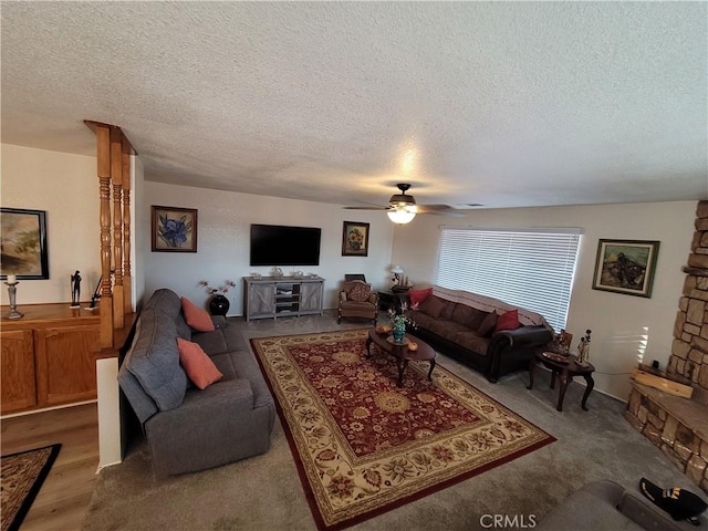 living room featuring a textured ceiling and ceiling fan