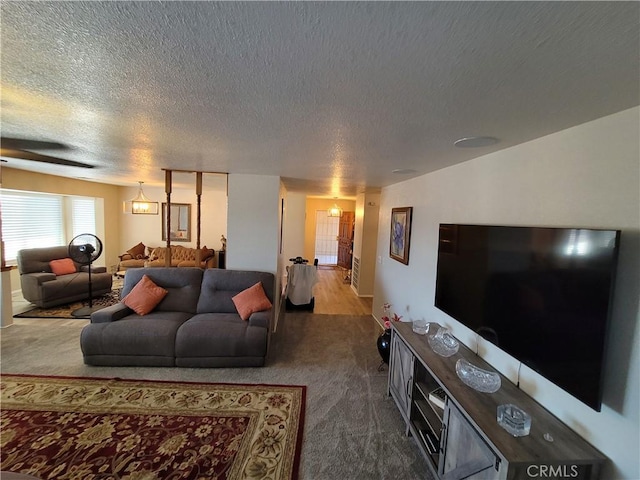 carpeted living room featuring a textured ceiling