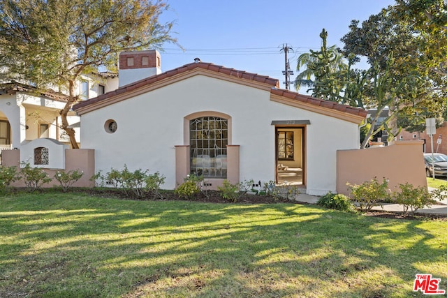 mediterranean / spanish-style home with a front lawn