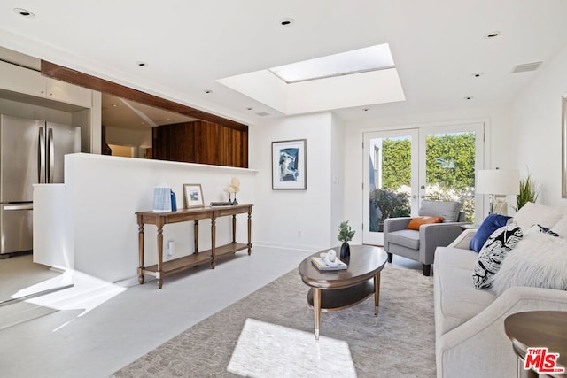 living room with a skylight and french doors