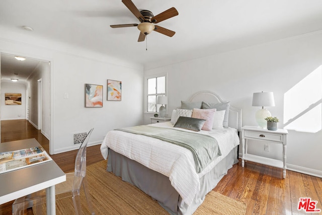 bedroom with ceiling fan and dark hardwood / wood-style flooring