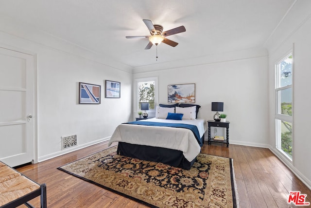 bedroom featuring crown molding, hardwood / wood-style floors, and ceiling fan