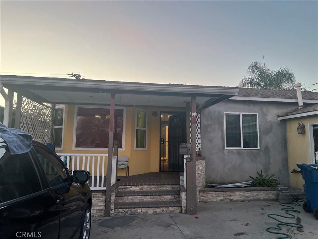 view of front of home with a porch and a patio