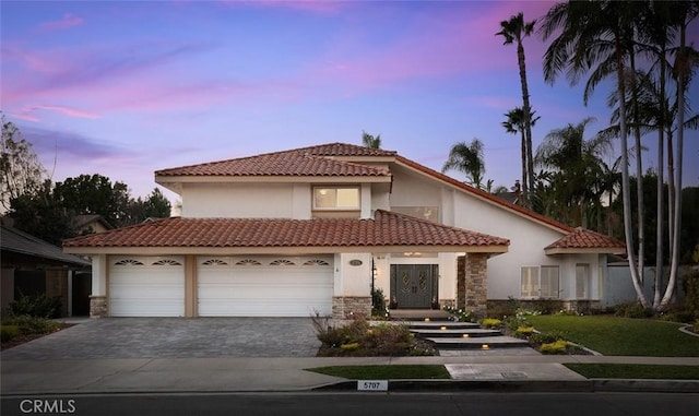 mediterranean / spanish-style house with a garage