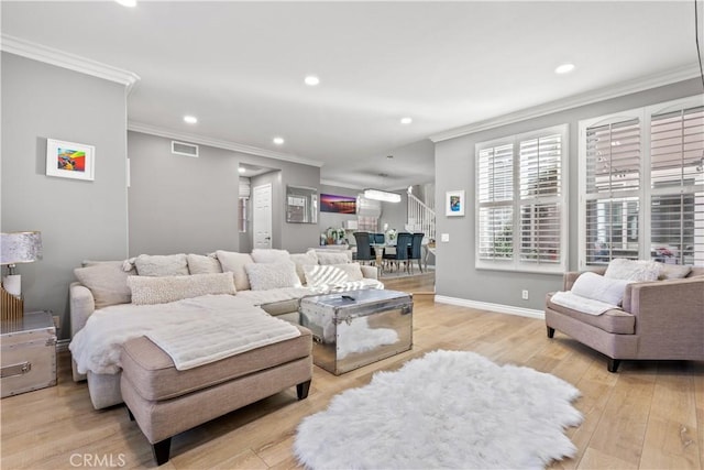 living room featuring light hardwood / wood-style flooring and crown molding