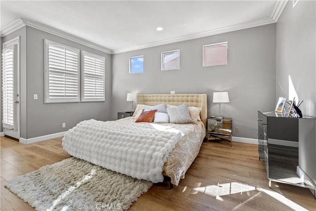 bedroom with light hardwood / wood-style flooring and ornamental molding