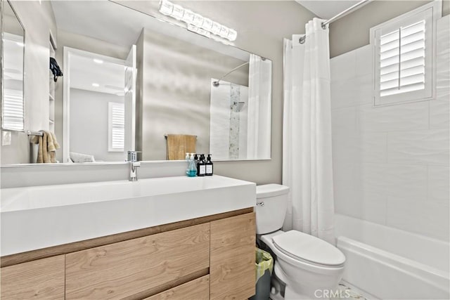 full bathroom featuring vanity, toilet, and shower / tub combo