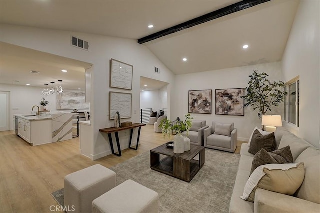 living area with vaulted ceiling with beams, light wood-style floors, visible vents, and recessed lighting