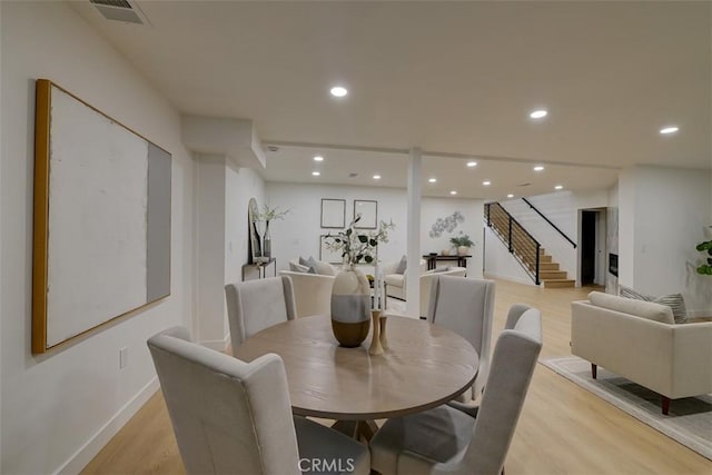 dining area featuring recessed lighting, visible vents, baseboards, stairs, and light wood finished floors