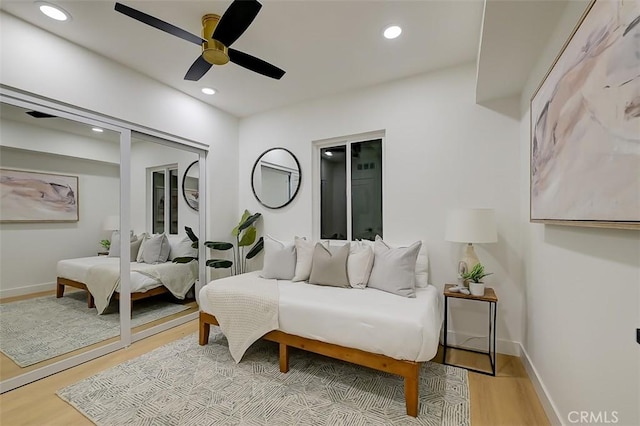 bedroom featuring baseboards, light wood-type flooring, and recessed lighting