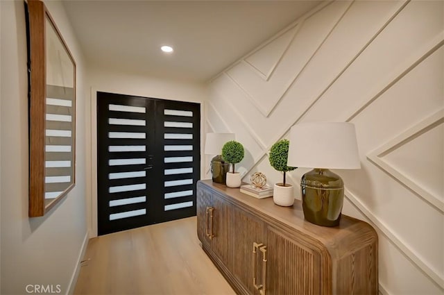 entryway featuring light wood-style floors, recessed lighting, and french doors