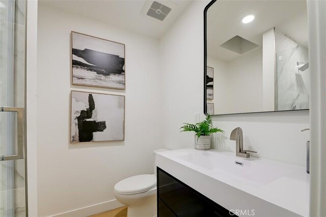 bathroom featuring toilet and vanity